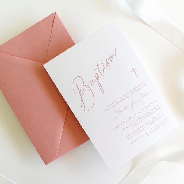 A baptism invitation with simple cursive writing and envelope